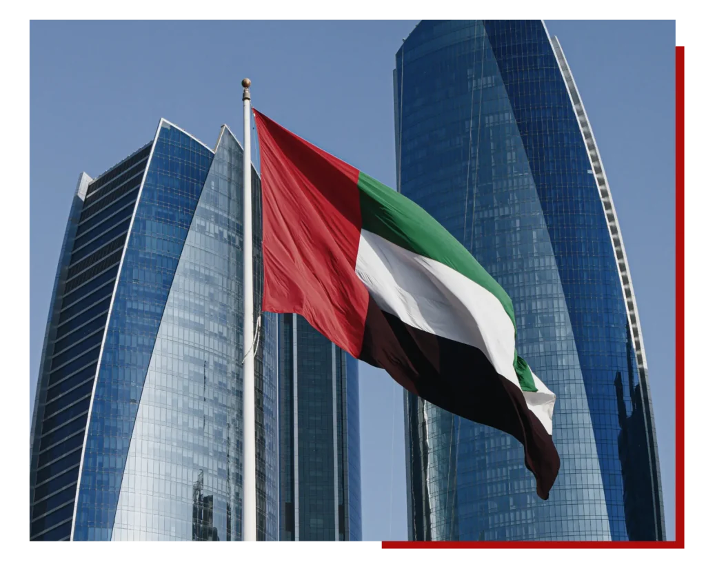 UAE flag waving in Dubai skyline, United Arab Emirates national flag on modern city background, Middle East business hub